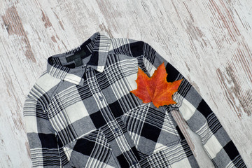 Checkered shirt and maple leaves. Fashionable concept