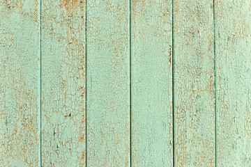 Fototapeta na wymiar Vertical slats, old green cracked paint. Background