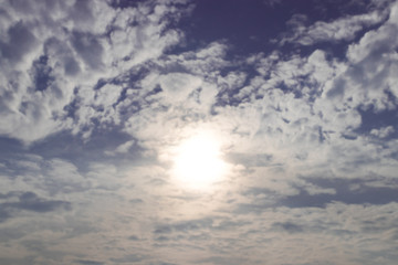The spread clouds in dark blue with sun shining