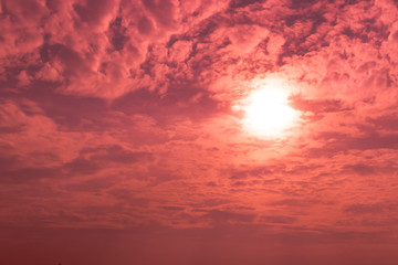 Abstract of the sun glowing in the red sky
