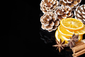 Christmas background with cones, orange and cinnamon stick