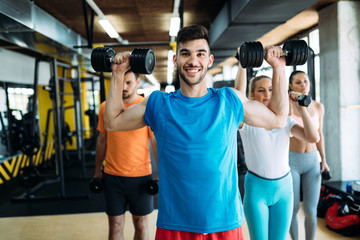 Fototapeta premium Group of friends exercising together in gym