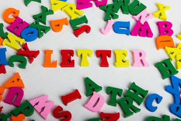 The word letter from the colorful wooden letters on a white wooden background
