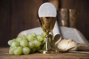 Symbol christianity religion a golden chalice with bread wafers