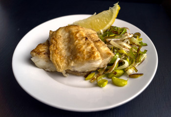 Grilled fish with leek and lemon.