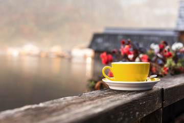 Yellow coffee cup on a wooden board