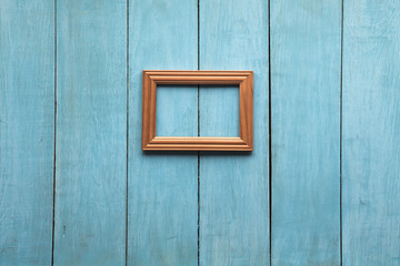 wooden photo frame on wooden wall