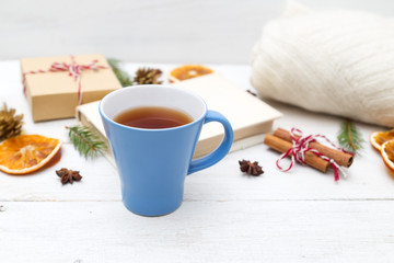 Obraz na płótnie Canvas Cup with hot tea and Christmas decorations on a wooden background. Cozy