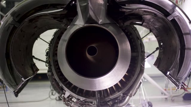 Engine of the airplane under heavy maintenance. Aircraft maintenance, dismantled plane engine. Chassis of the airplane under heavy maintenance