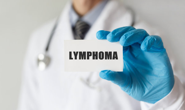 Doctor holding a card with text LYMPHOMA ,medical concept