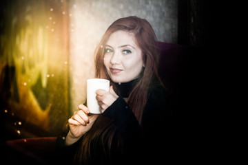 Beautiful girl drinking coffee at the coffee shop