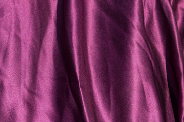 Fototapeta na wymiar Purple satin background. Silk texture. Fabric pattern