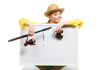 Happy woman with fishing rod holding board