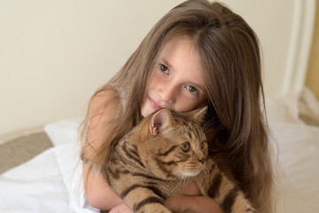 Portrait of little girl holding her cat