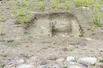 View of an empty grave ground. Open dumping. Religious place. Daylight.