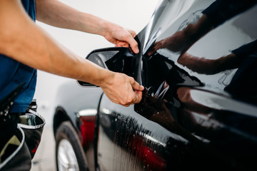 Specialist work with car, tinting film installing