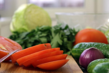 tomato sliced, surrounded by veggies