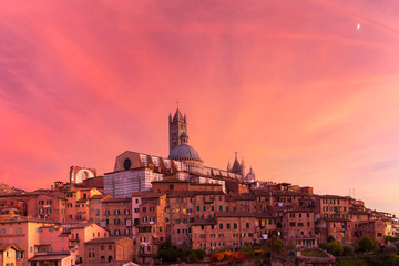 Beautiful view of Dome and campanile of Siena Cathedral, Duomo di Siena, and Old Town of medieval city of Siena at gorgeous sunset, Tuscany, Italy - obrazy, fototapety, plakaty