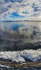 Frozen Lake with Volcano blue Sky and Snow reflection white in I
