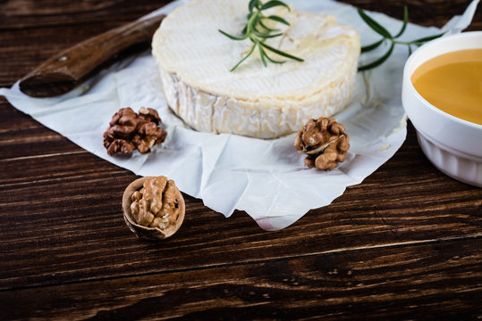 Camembert cheese with nuts and  honey. Selective focus