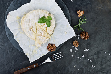 Camembert cheese with nuts. Flat lay.