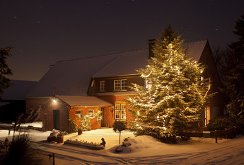 Winter House With Tall Christmas Tree At Night - 179558140