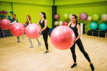 Women group with big balls doing exercise, fitness