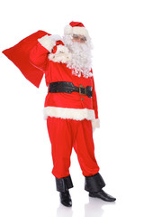 Santa Claus carrying big bag. Isolated on white background. Full length portrait
