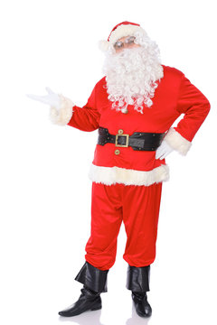 Santa Claus standing with a welcome gesture isolated on white background. Full length portrait