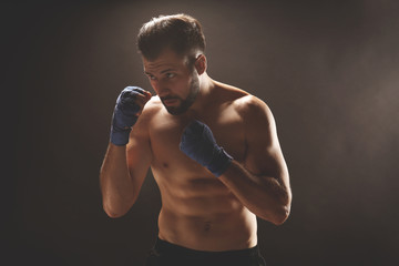 Male boxer on dark background