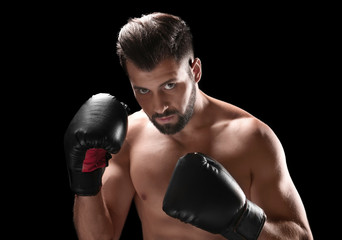 Fototapeta na wymiar Male boxer on dark background