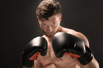 Fototapeta na wymiar Male boxer on dark background