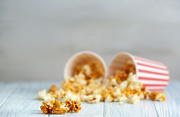 Tasty caramel popcorn on wooden table