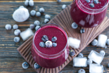 Glass with acai juice on wooden board