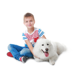 Cute little boy with dog on white background