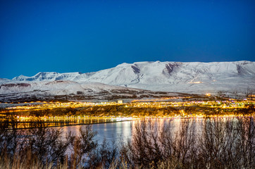 Panoramic view on Akureyri city night in winter with snow at nig