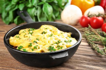 Pan with potato casserole on wooden table