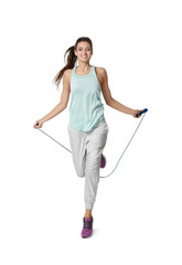 Young woman with jumping rope on white background