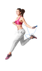 Young woman with jumping rope on white background