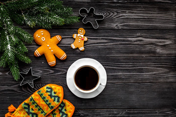 Cozy christmas evening. Coffee, cookies, spruce branch, knitten mittens on grey wooden background top view copyspace
