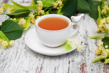 Obraz na płótnie Canvas cup of herbal tea with linden flowers