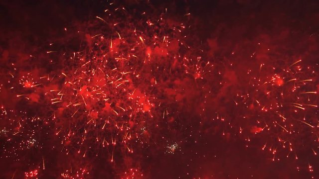 4K video footage of colorful bright pyrotechnic show, flashes of salute firework of different colors close up view