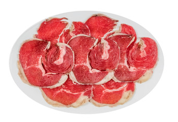 raw beef fillets on a plate .