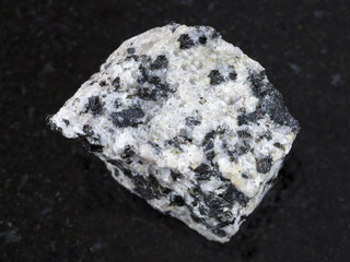 raw white granite stone on dark background