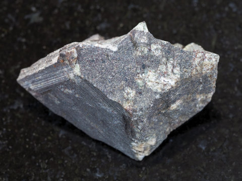 rough porphyritic Basalt stone on dark