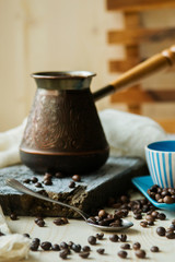 Coffee cup and metal turk on burlap background
