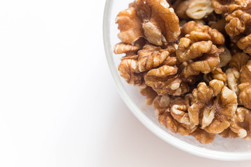 Walnuts in a bowl  / healthy fitness food of the white background
