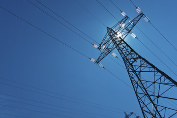 electricity pylon with sun and sky