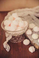 vanilla and raspberry homemade zephyr close-up in wooden box on dark stone background. sweet delicious pink and white marshmallows, selective focus