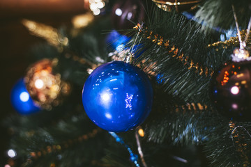 Fototapeta na wymiar Christmas toys balls close-up on a festive tree backgrounds